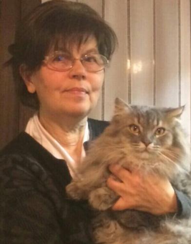 a woman holding a gray cat in her arms at B&B SCACCIA PENSIERI in Tarcento