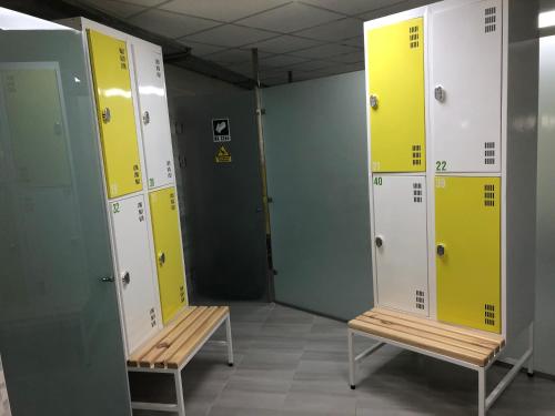 a row of lockers in a locker room with benches at КРЕМІНЬ in Dragobrat