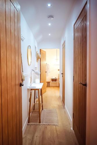 a hallway with a table and a desk in a room at At The River in Dundee