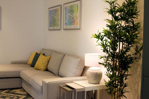 a living room with a couch and a plant at Casas Madre de Deus in Évora