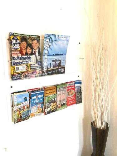 a display of magazines and newspapers on a wall at Ferien-Whg Möwe nahe Steinhuder Meer mit Garten und Balkon in Hagenburg