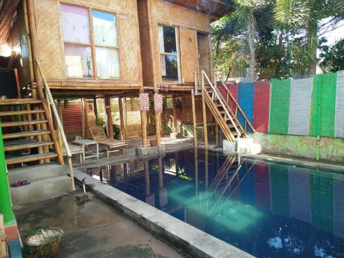 a house under construction with a swimming pool at Little Woodstock Homestay in Gili Trawangan