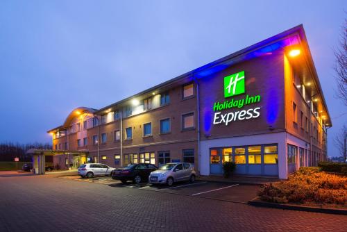 a building with a sign that reads hospital inn express at Holiday Inn Express East Midlands Airport, an IHG Hotel in Castle Donington