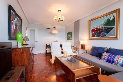 a living room with a couch and a table at Bakio Beach VIII by Aston Rentals in Bakio