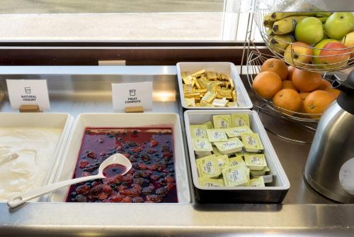 a kitchen counter filled with lots of different types of food at Holiday Inn Express Birmingham Star City, an IHG Hotel in Birmingham