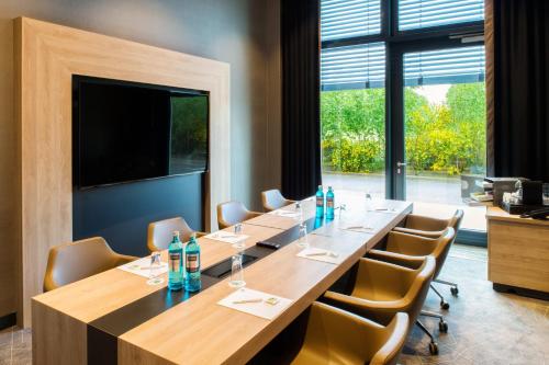a conference room with a long table and chairs at Holiday Inn Frankfurt Airport by IHG in Frankfurt/Main