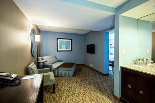 a hotel room with a couch and a living room at Crowne Plaza Hotel Glen Ellyn/Lombard by IHG in Glen Ellyn