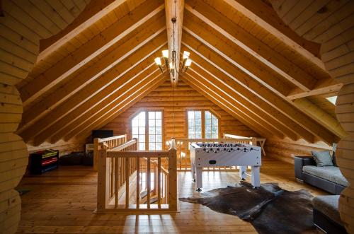 una habitación con una mesa en medio de un ático en Luxus-Ferienhaus Blockhaus Chalet Nr 3 Toplage am Feldberg mit Sauna, Outdoor-Hottub, Kamin auf 1300m üM, en Feldberg