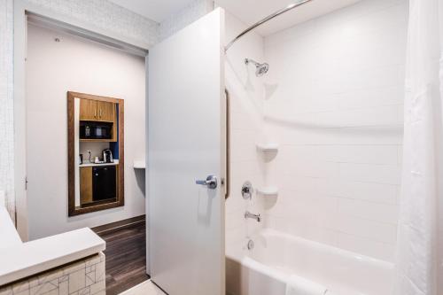 a white bathroom with a shower and a tub at Holiday Inn Express & Suites - West Edmonton-Mall Area by IHG in Edmonton