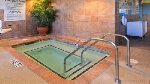 a hot tub in a bathroom with a sink at Holiday Inn Express Woodland by IHG in Woodland