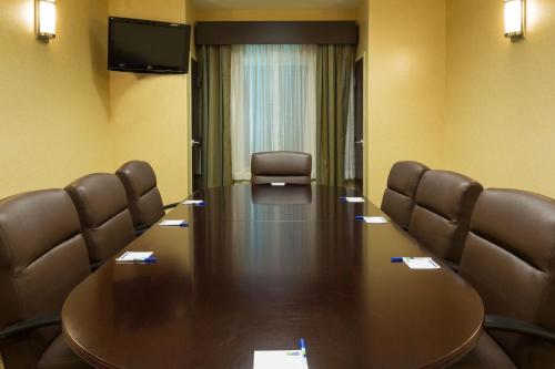 a room with a table, chairs, and a mirror at Holiday Inn Express & Suites Moultrie, an IHG Hotel in Moultrie