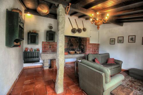 a living room with a couch and a fireplace at Quinta de São Roque in Vila Nova de Cerveira
