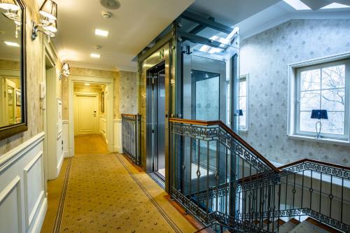 a hallway with a staircase with a yellow door at Zamek Topacz in Wrocław