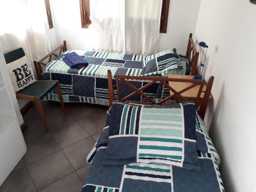 a group of three beds in a room at Chalet Las Nenas B&B in Mar del Plata