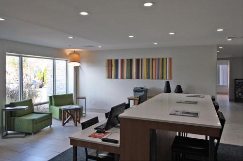 a living room with a table and chairs at Holiday Inn Express Branford-New Haven by IHG in Branford