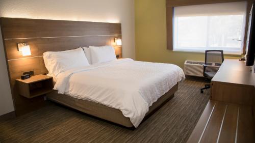 a hotel room with a large bed and a window at Holiday Inn Express & Suites Colorado Springs North by IHG in Colorado Springs