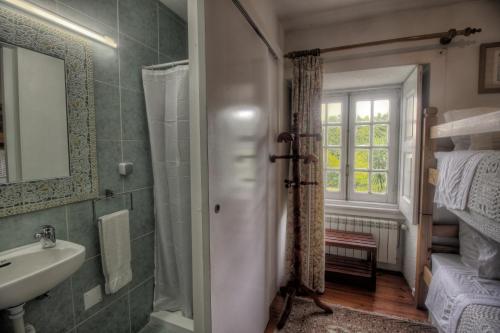 a bathroom with a sink and a mirror at Quinta de São Roque in Vila Nova de Cerveira