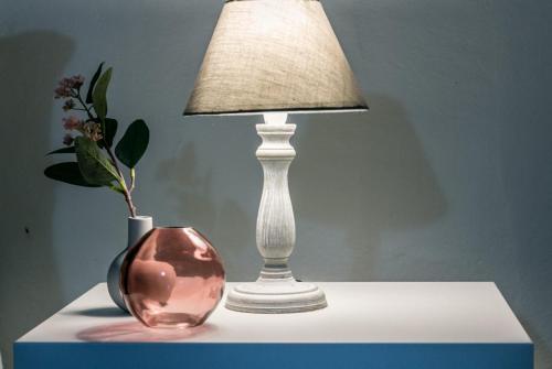 a lamp and a vase sitting on a table at Design Apartments Sassari-Skyline in Sassari