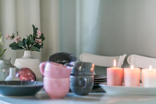 a table with candles and plates and flowers on it at Design Apartments Sassari-Skyline in Sassari