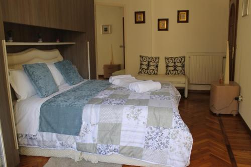 a bedroom with a large bed and a couch at BEAUTIFUL HOLIDAY HOUSE by Marcos in Sanremo