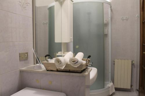 a bathroom with a basket of towels on a sink at BEAUTIFUL HOLIDAY HOUSE by Marcos in Sanremo