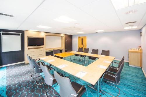 a conference room with a large table and chairs at Holiday Inn Express Folkestone Channel Tunnel by IHG in Folkestone