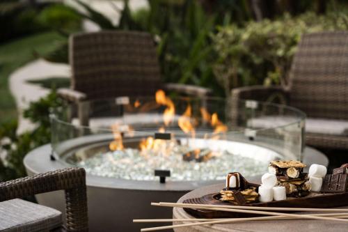 a table with a fire pit on a patio at Hyatt Regency Huntington Beach Resort and Spa in Huntington Beach