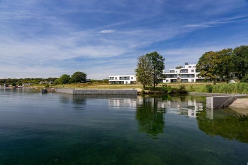 a large body of water with buildings in the background at Golden Lakes Hotel in Boussu-lez-Walcourt