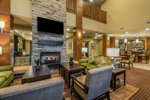 a living room with couches and a fireplace at Staybridge Suites Longview, an IHG Hotel in Longview