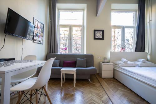 a small living room with a couch and a desk at Elegant Apartment Copernicus in Warsaw