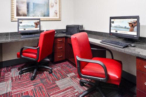 an office with two red chairs and a desk with two monitors at Holiday Inn Express Canandaigua by IHG in Canandaigua