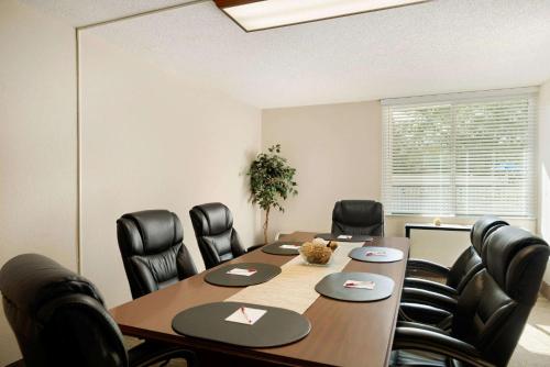 a conference room with a table and black chairs at Wyndham Garden Tallahassee Capitol Near FSU in Tallahassee