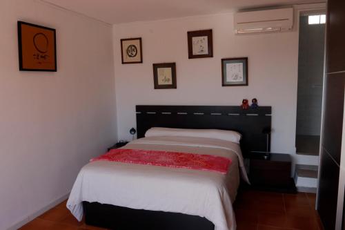 a bedroom with a bed with a red blanket at Villa Teresa in Agua Amarga
