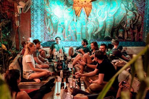a group of people sitting in a room at Los Amigos Hostel in Flores