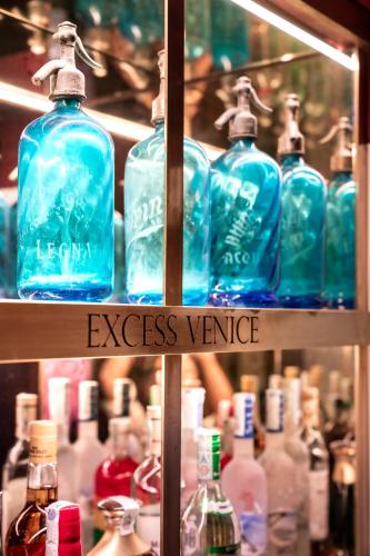 a group of blue bottles on a shelf at Excess Venice Boutique Hotel & Private Spa - Adults Only in Venice
