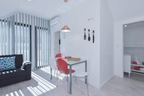 a living room with a table and chairs and a couch at Near The Beach Apartments in Matosinhos