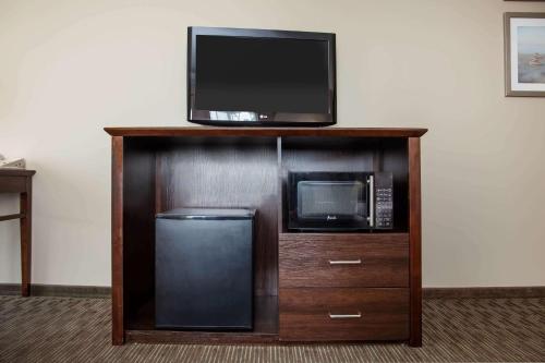 a entertainment center with a microwave and a tv on top at La Quinta by Wyndham Inglewood in Inglewood