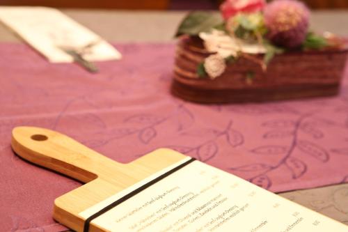 a wooden spoon and a book on a table at Gasthof Hotel Adler Inneringen in Inneringen-Hettingen
