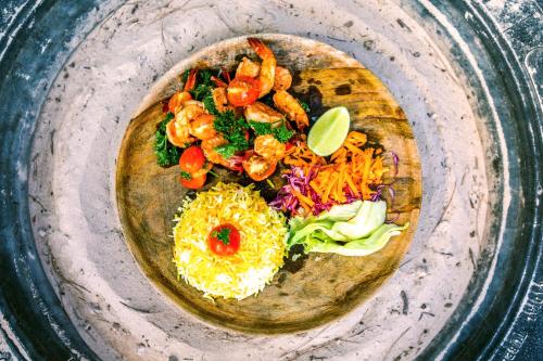a plate of food with shrimp and vegetables on it at Salty's Kitesurf Village in Kilifi