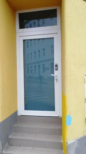 a white door with a window on a building at Gloriette Aparts - Wien Schönbrunn in Vienna
