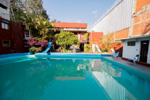 a swimming pool with a slide in a building at Arisa in Oaxaca City