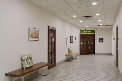 a hallway of a hospital with benches and a door at Wyndham Garden Tallahassee Capitol Near FSU in Tallahassee