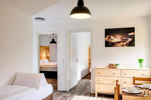 a bedroom with a bed and a dresser and a bedroom at Fischer Ferienhaus in Tweng