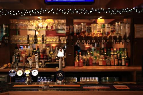 
a bar that has a lot of drinks on it at Station Hotel in Gloucester
