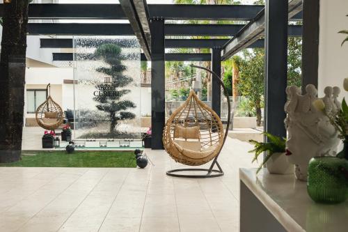 a room with two hanging hammocks in a building at Hotel Cerere in Paestum