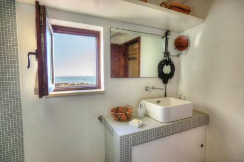 baño con lavabo y ventana en Casa Eu - Bilocale Ortigia Wifi, en Siracusa