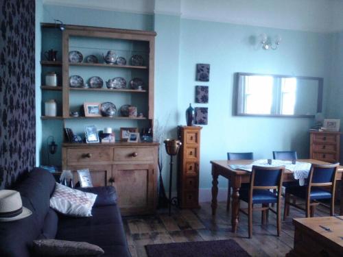 a living room with a couch and a table at Seahaven House in Ryde