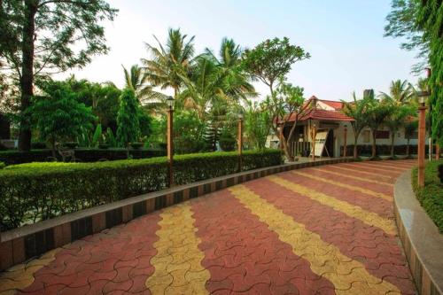 a red and yellow brick road in front of a house at Anandvan Holiday Homes, Wai in Wai
