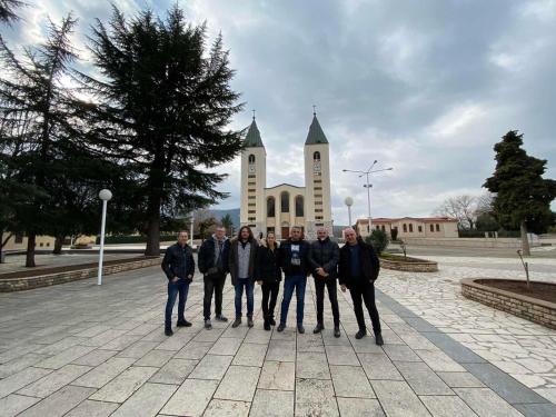 a group of people standing in front of a church at Rooms Ivan-Popić in Međugorje
