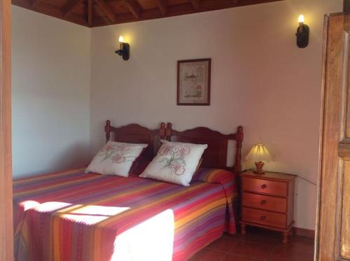 a bedroom with a bed with two pillows on it at Under the Palm-trees in Breña Baja